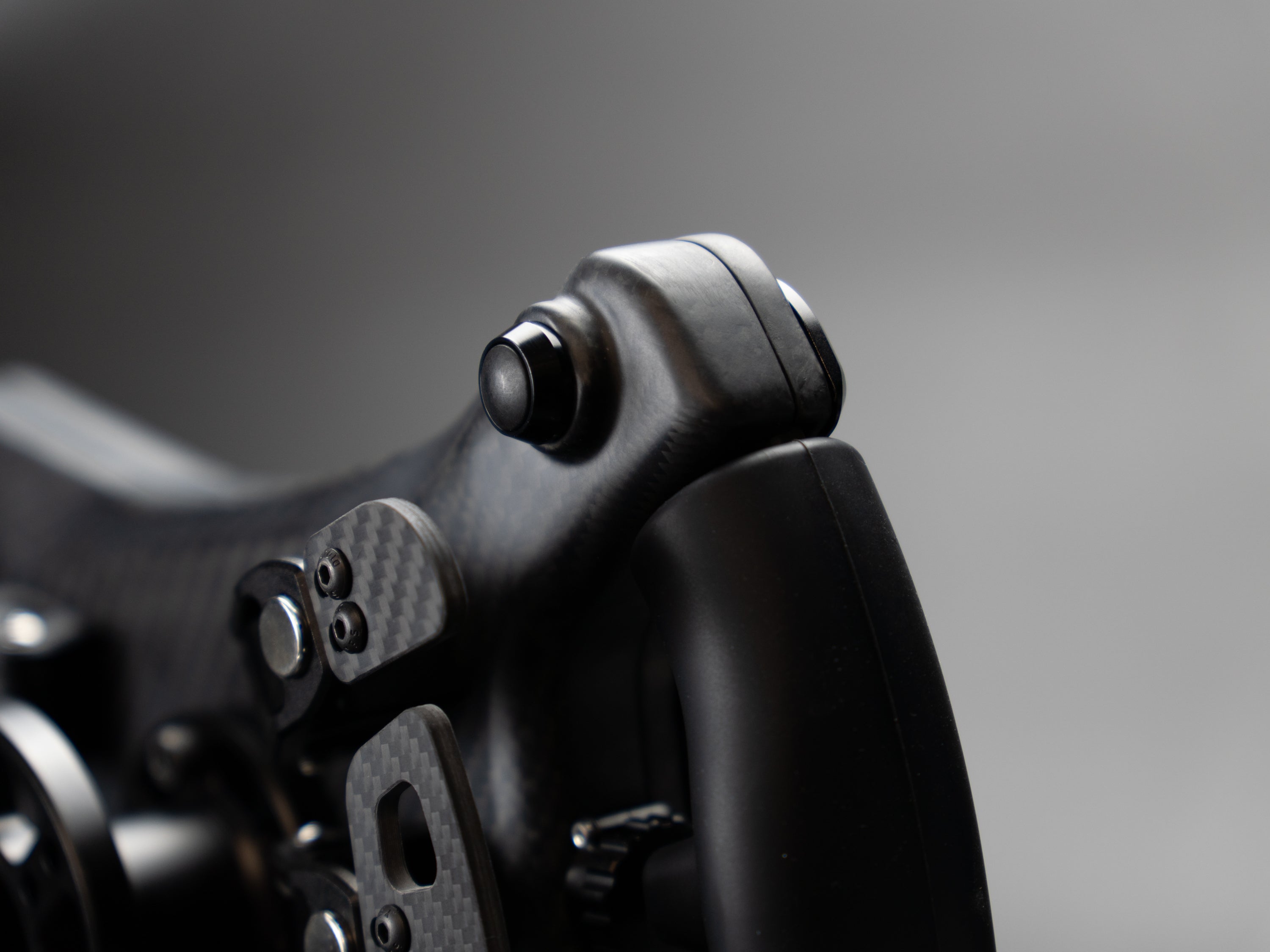 Silicone grip and rear button on the PGT Vector steering wheel
