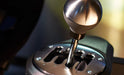 Close-up of the TH8A H-pattern shift plate and metal knob