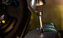 TH8A metal gear stick next to a racing wheel
